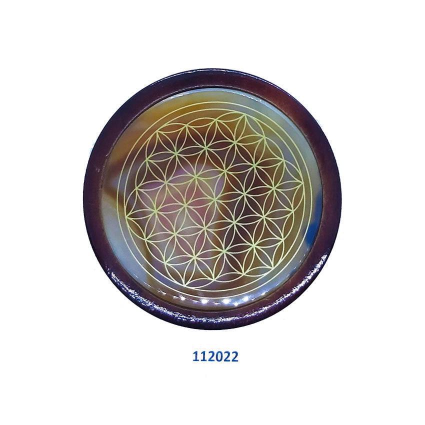Flower of life on agate gemstone coaster surrounded with wood.