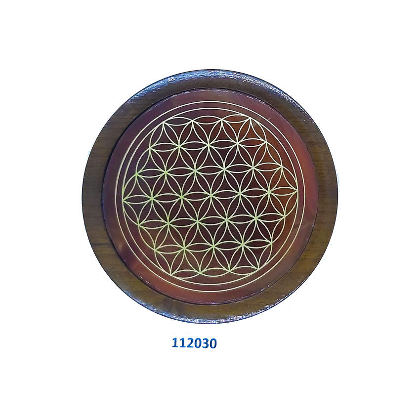 Flower of life on agate gemstone coaster surrounded with wood.