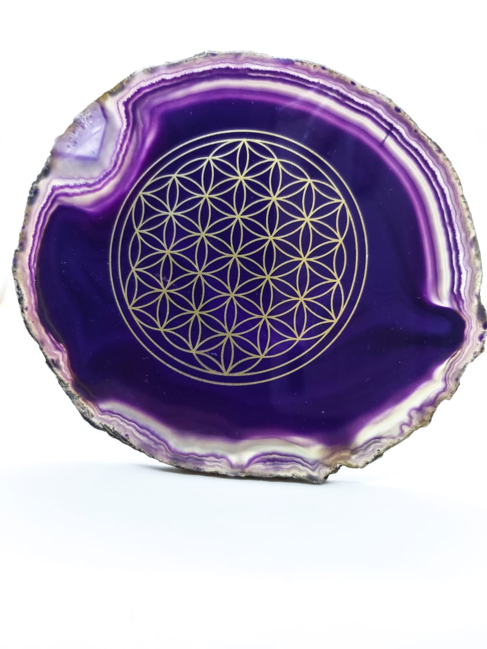 Flower of life on a natural shape purple agate gemstone